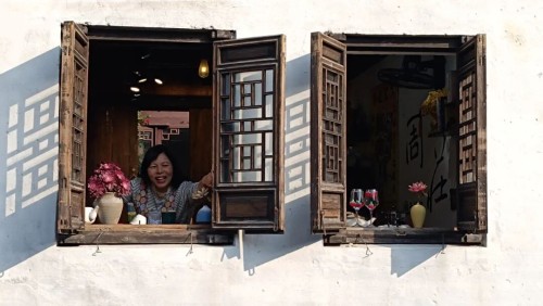 Y17 - 金自成 -《小店窗口》25 年 4 月 9 号在周庄，见小店女主人正笑着推开窗户，意境很好，就拍下了这一刻.jpg
